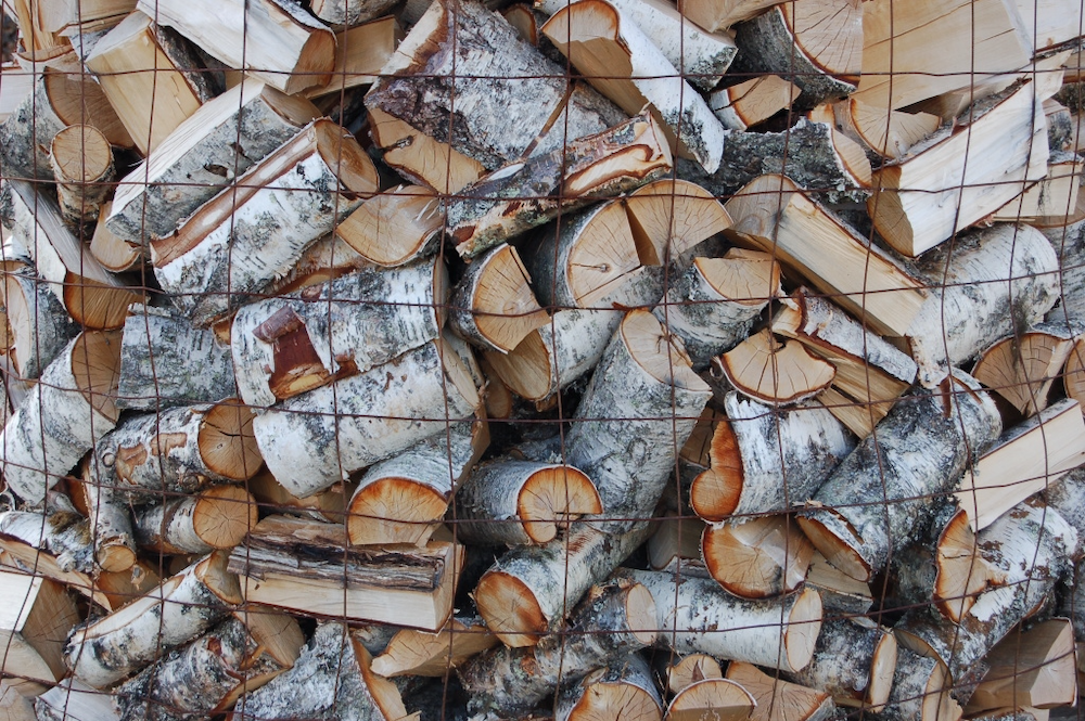 Logs kept together with wire mesh fence