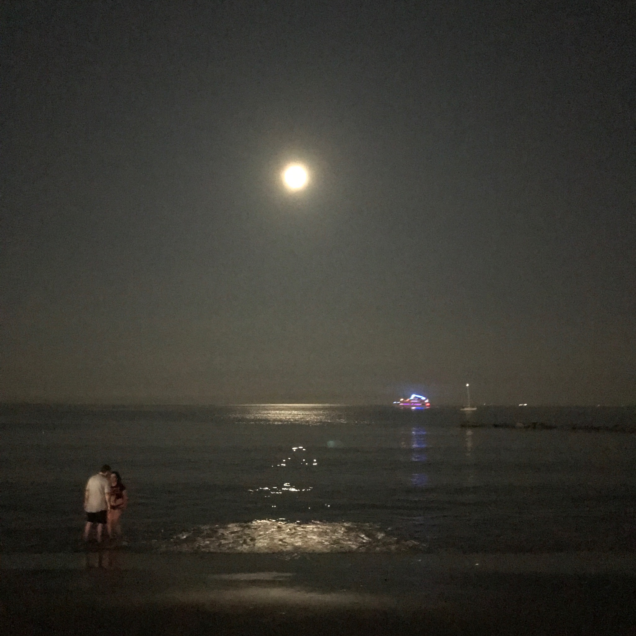 Coney Island couple's 4th of July beachside midnight near embrace