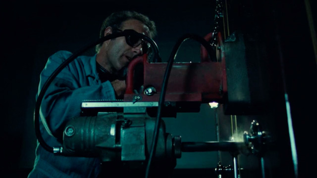 Snap from the 1981 movie Thief showing the main character drilling a safe