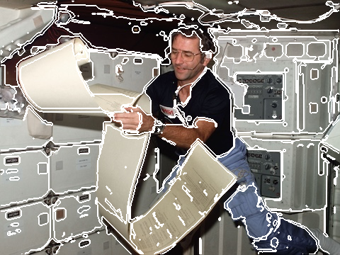 Dick Truly perusing teleprinter copy, floating partially about the middeck area of NASA's space shuttle Columbia during one of 1813 minutes of STS-2 activity, graph cut